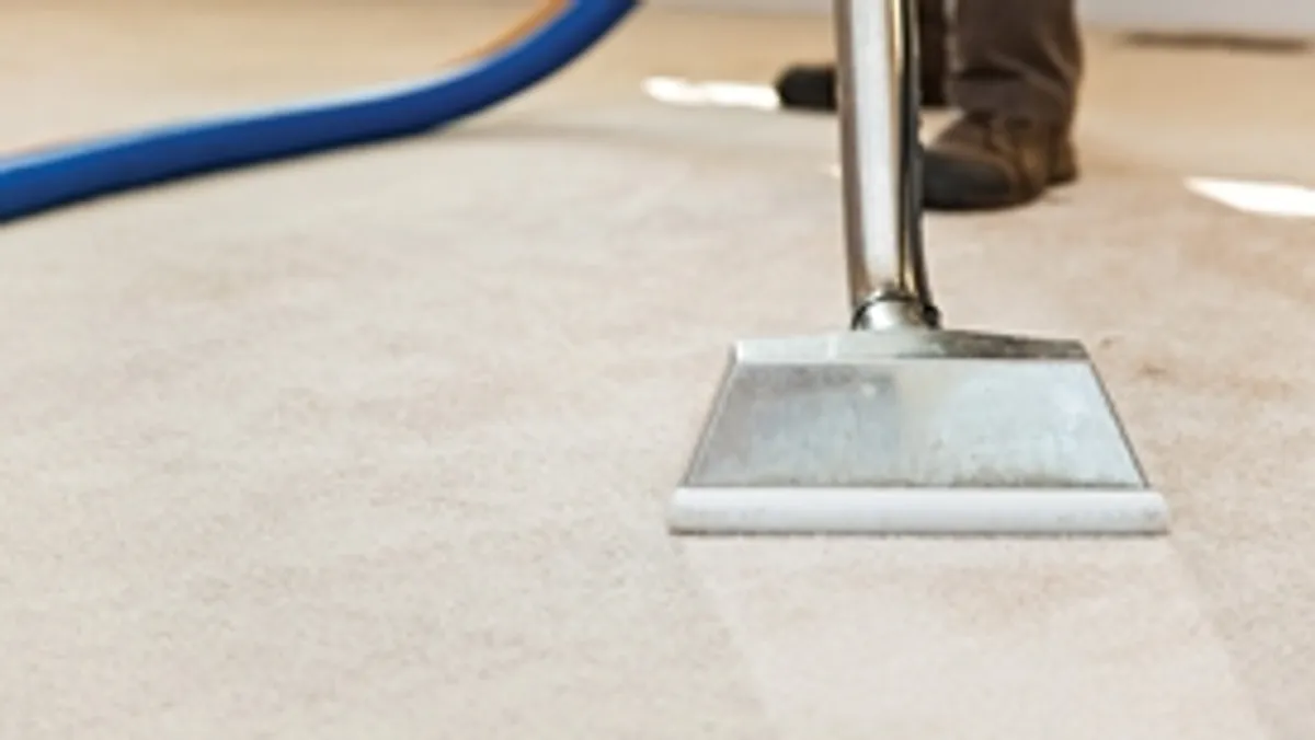 Carpet cleaning wand head gliding over a light carpet during hot-water extraction, Myrtle Beach, SC.